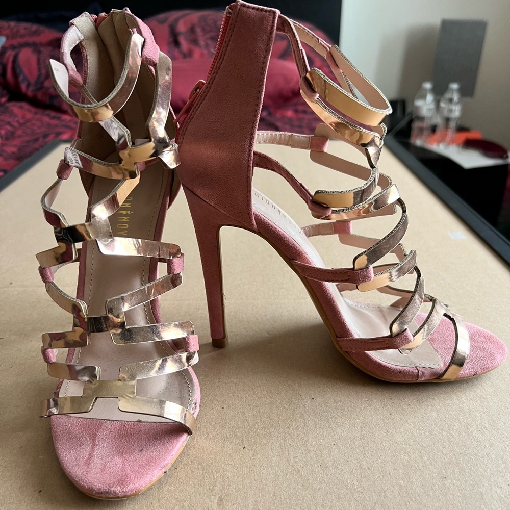 Pink and gold strappy heeled sandals.
